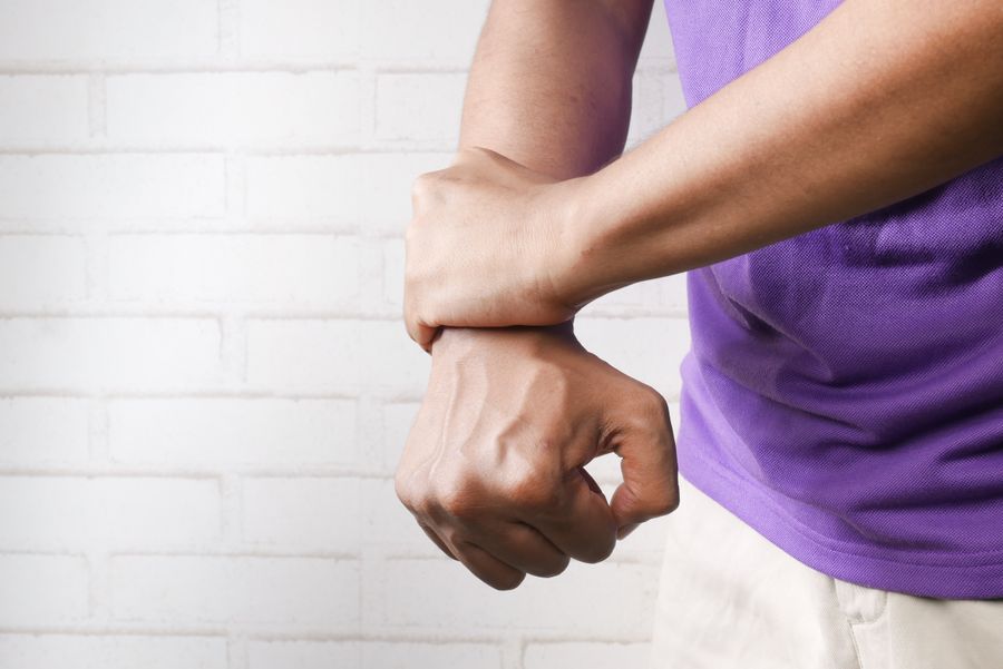 Person experiencing wrist pain and discomfort from carpal tunnel syndrome