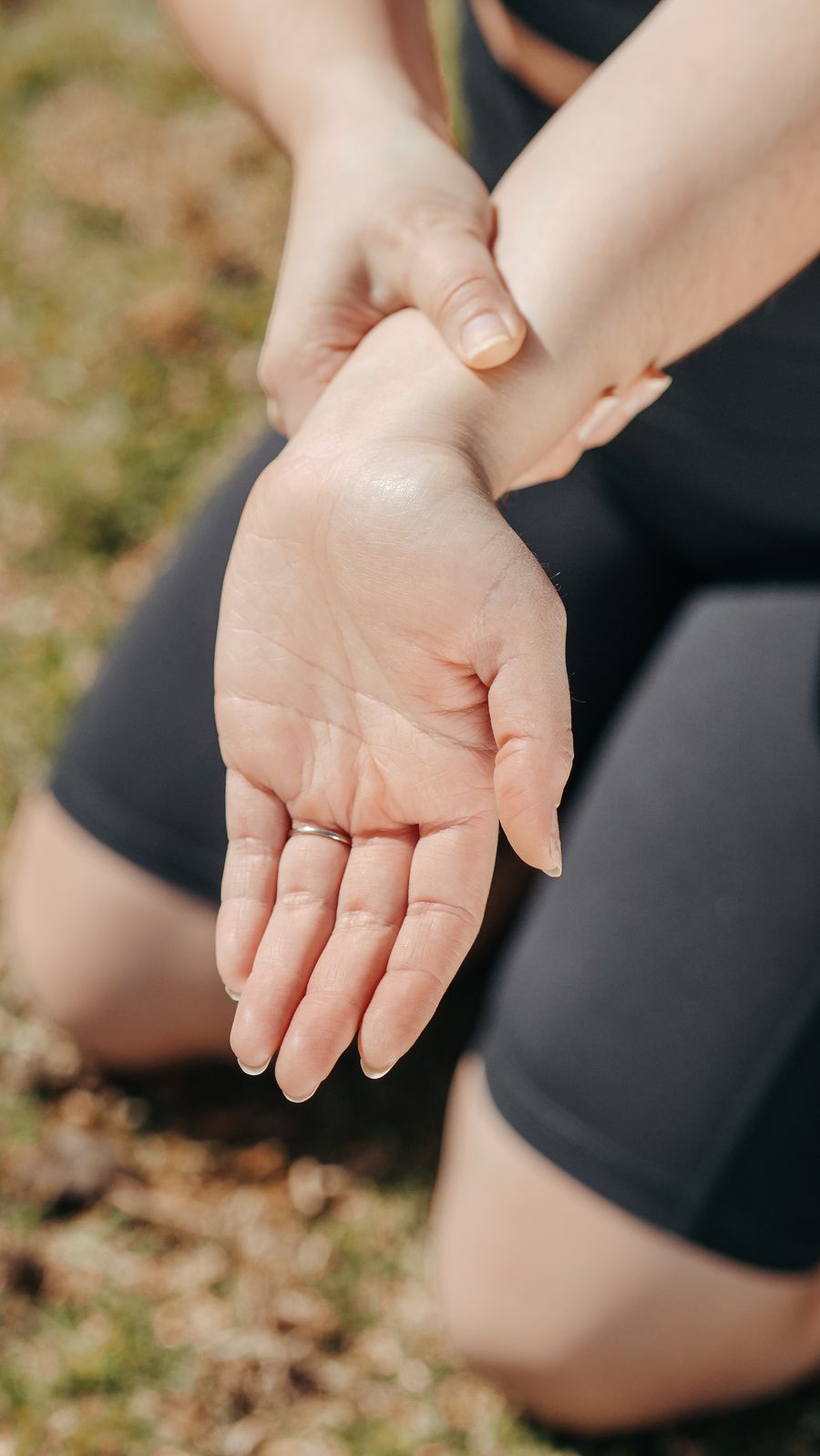 Person holding their wrist in pain — a hallmark symptom of de Quervain's tenosynovitis