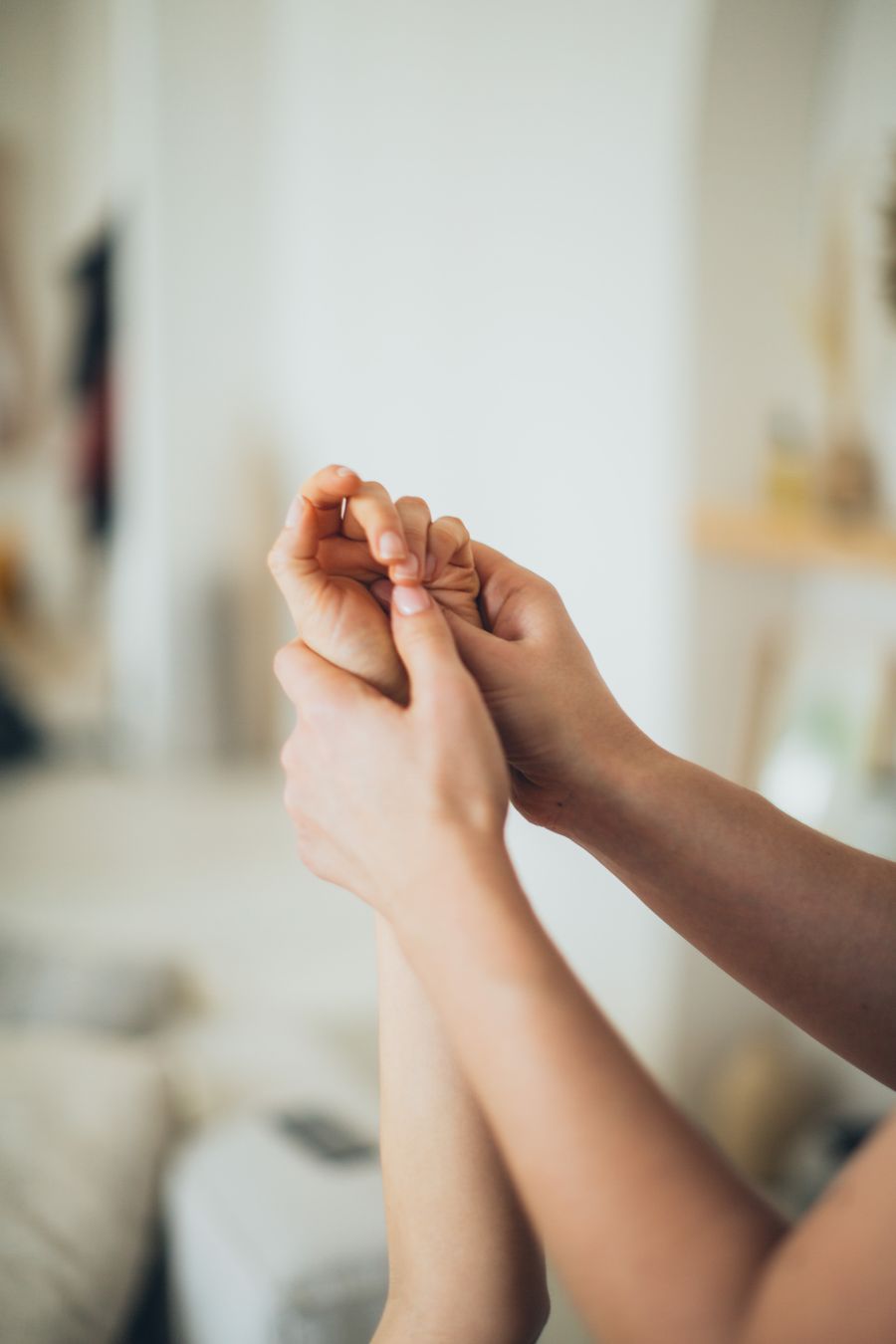 Therapist gently working the palm and fingers during post-Dupuytren's procedure rehabilitation