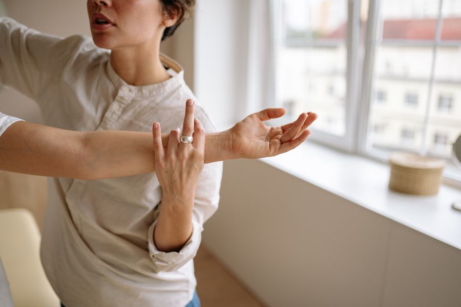 Therapist assisting a patient with arm stretching exercises to restore nerve function